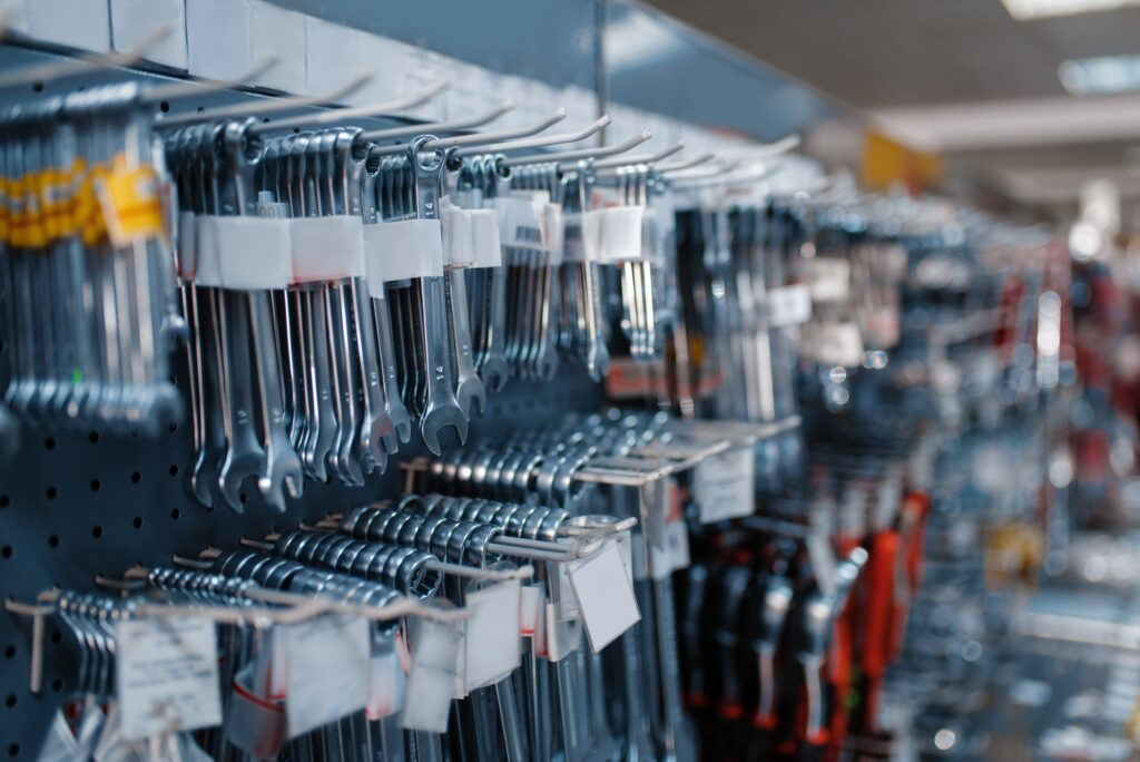 Wrenches on racks in tool store closeup, nobody